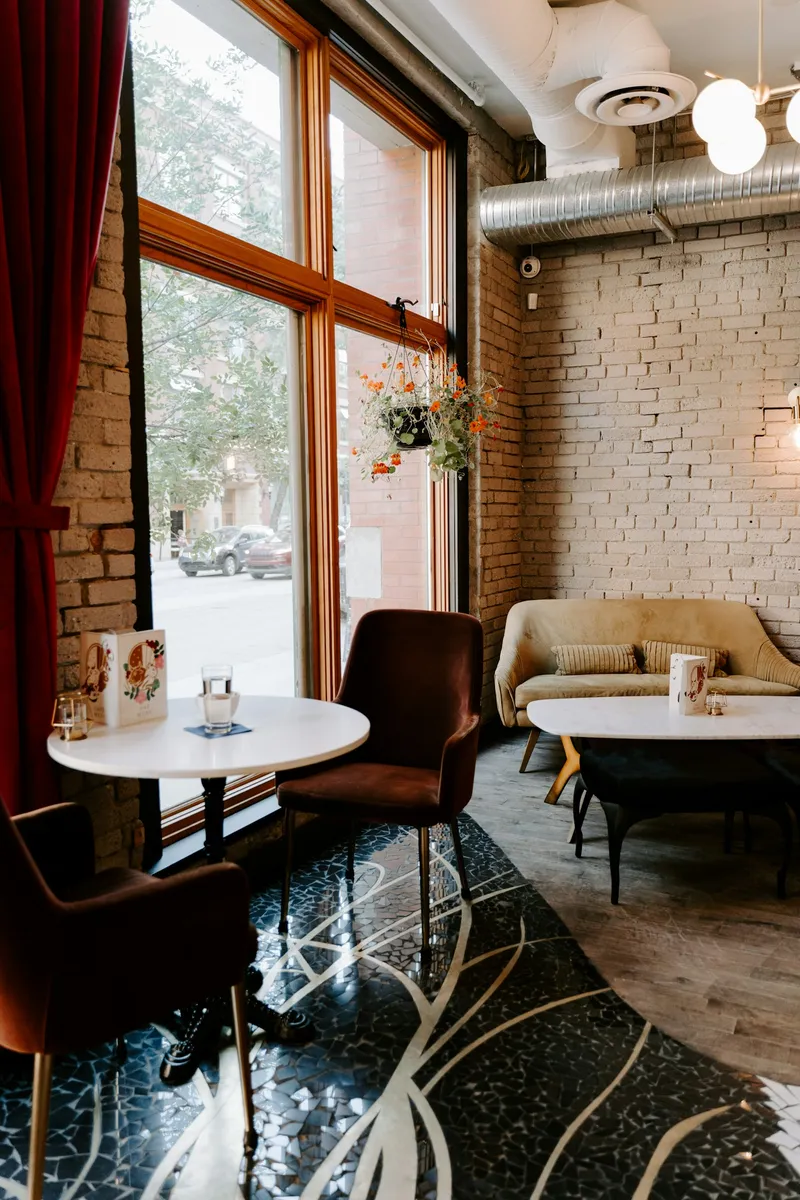 Sunlit corner seating with cushioned benches inside Dreamlight Cafe