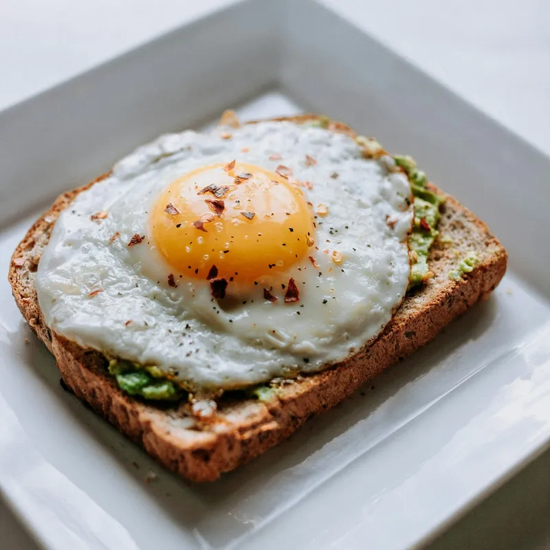 A brunch plate — a fried egg on avocado sourdough toast