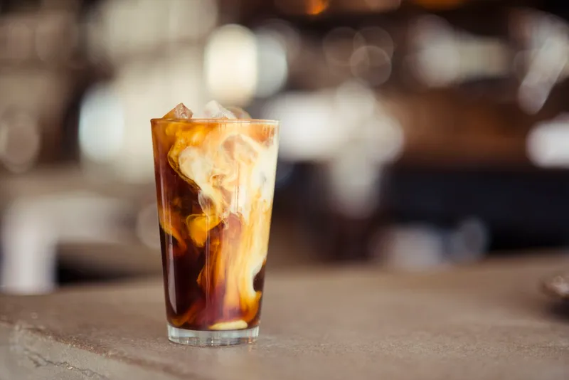 A glass of iced cold brew coffee catching the light